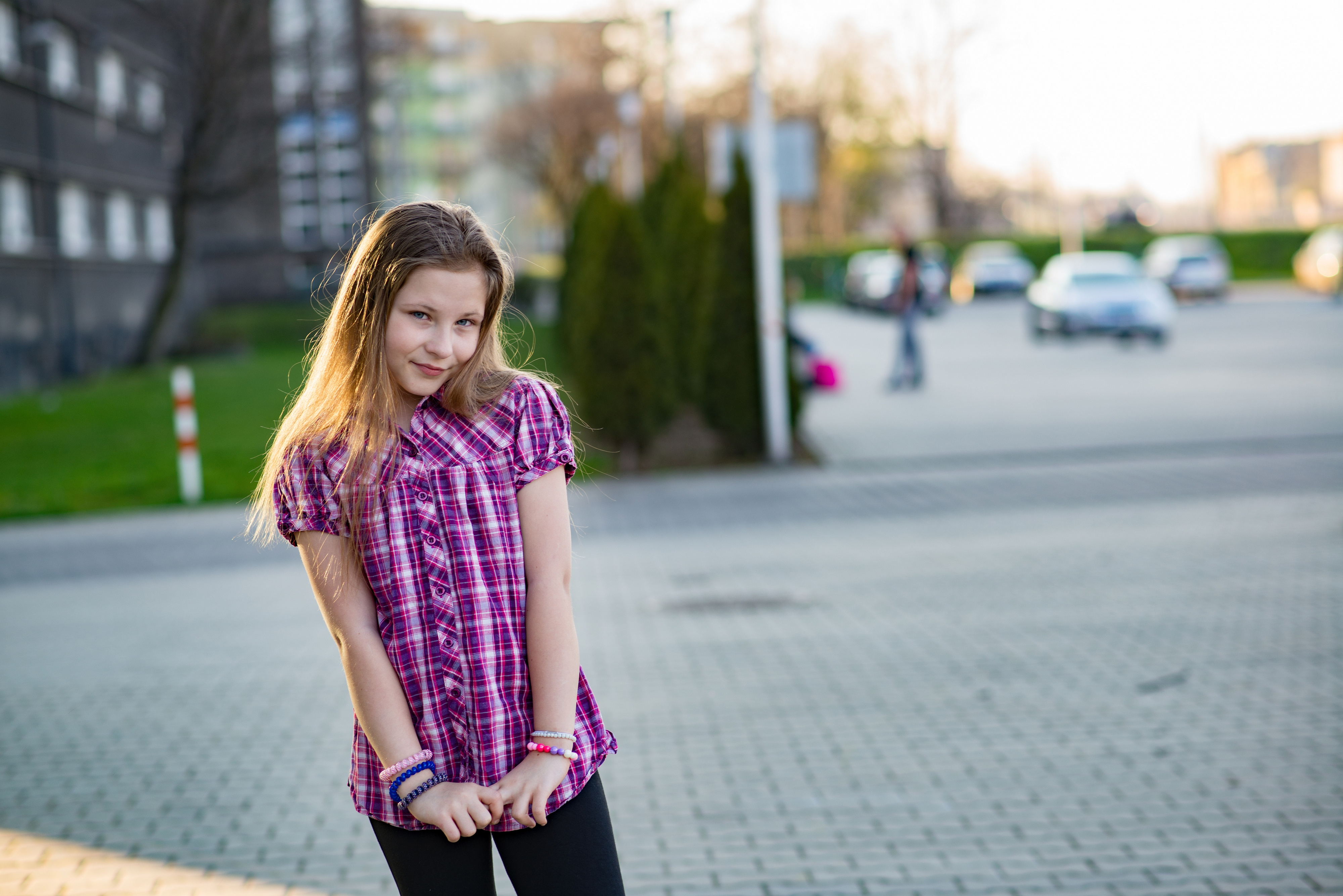 A 10 years old girl in a checked shirt