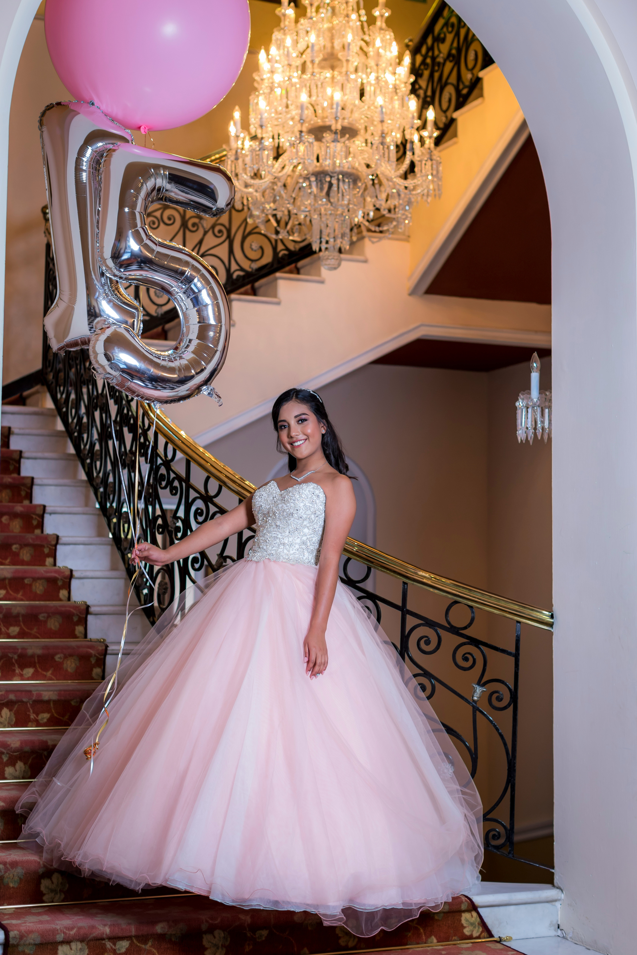 A Young Woman in White and Pink Gown Holding Inflatable Balloon